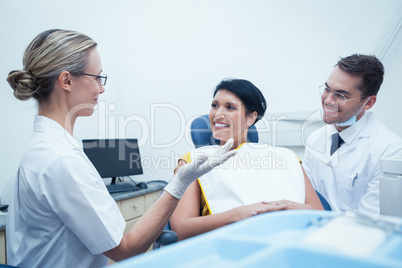 Male dentist and assistant with female patient