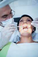 Male dentist examining womans teeth
