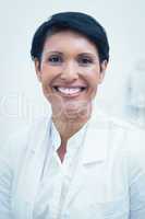 Confident female dentist smiling