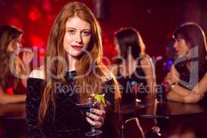 Pretty redhead drinking a cocktail