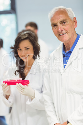 Lecturer and student smiling at camera in the lab