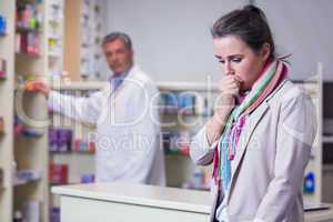 Portrait of a sick girl with scarf coughing