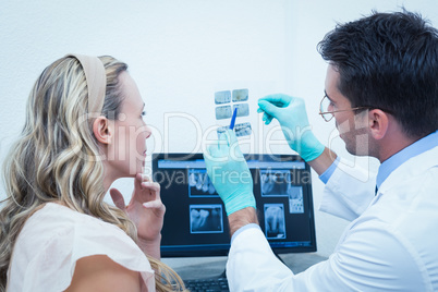 Dentist showing woman her mouth x-ray