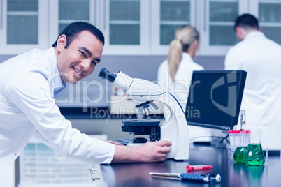 Science student working with microscope in the lab