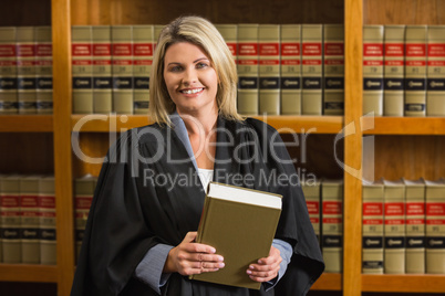 Lawyer holding book in the law library