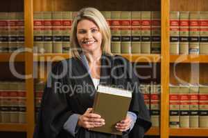 Lawyer holding book in the law library