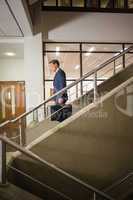 Businessman going down the stairs