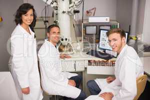 Biochemistry students using large microscope and computer