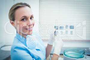 Portrait of female dentist holding x-ray