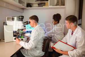 Science students looking through microscope