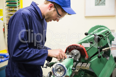 Engineering student using heavy machinery