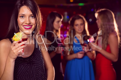 Pretty brunette drinking a cocktail