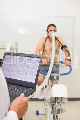 Man doing fitness test on exercise bike