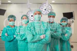 Medical student and lecturer looking at camera in scrubs