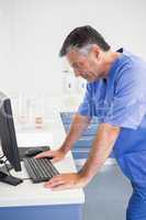 Dentist concentrated about computer monitor