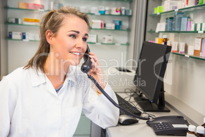 Young pharmacist on the phone Young pharmacist on the phone