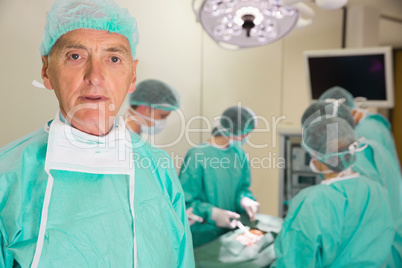 Medical professor looking at camera during fake surgery