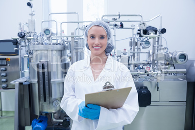 Portrait of a smiling scientist holding a clipboard