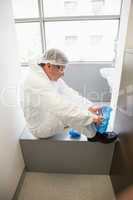 Pharmacist putting on his shoe covers