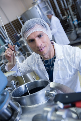 Smiling scientist using brewer in the container Smiling scientist using brewer in the container