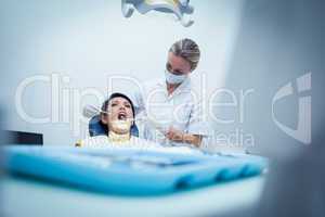 Female dentist examining womans teeth