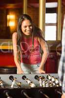 A brunette playing table football