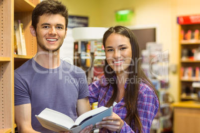 Smiling friends student holding textbook