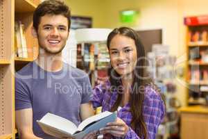 Smiling friends student holding textbook