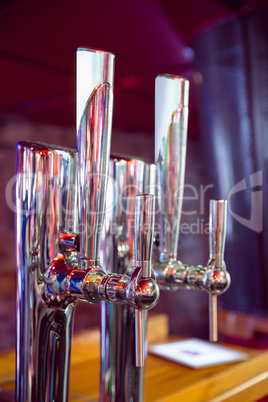 Shiny beer taps in a row