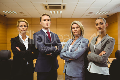 Portrait of four well-dressed lawyer with arms crossed