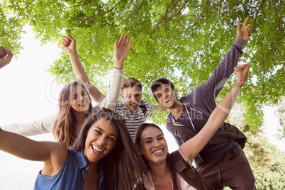 Happy students posing and smiling outside