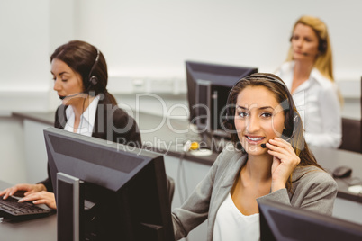 Smiling call centre agent talking on the headset