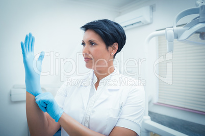 Dentist wearing surgical glove