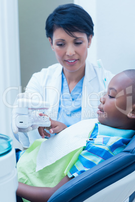 Dentist showing boy prosthesis teeth