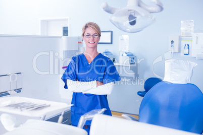 Dentist smiling at camera with arms crossed