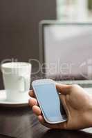 Student holding his mobile phone