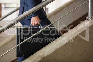 Businessman climbing up the stairs