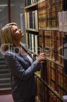 Lawyer picking book in the law library