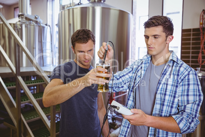 Two casual men testing beer