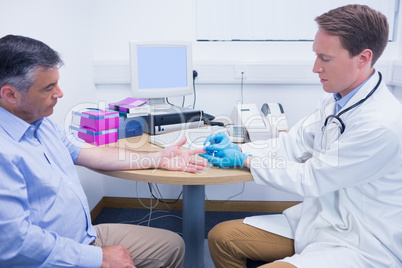 Doctor using a blood glucose meter