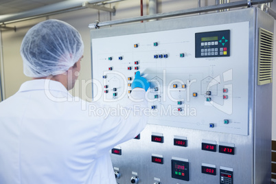 Scientist using the machine and pressing on buttons