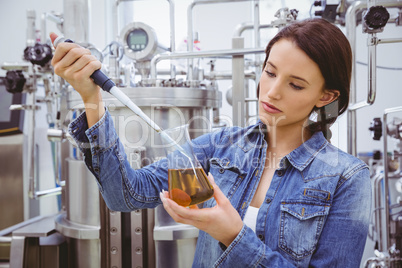 Scientist preparing an experiment with a pipette and beaker