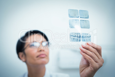 Female dentist looking at x-ray