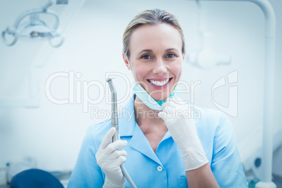 Female dentist holding dental tool