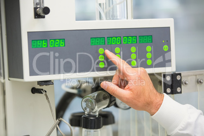 Pharmacist using machinery to make medicine