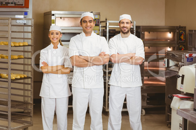 Team of bakers smiling at camera