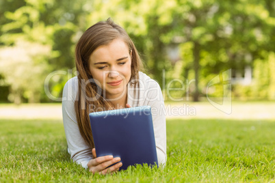 University student lying and using tablet pc