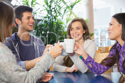 Young students having coffee together