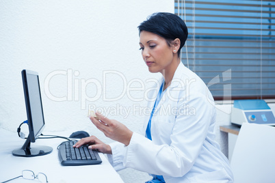 Dentist looking at mouth model by computer