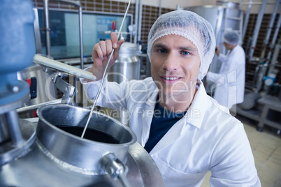 Smiling scientist using brewer in the container